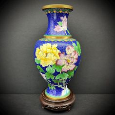 a blue vase with flowers painted on it