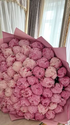 a bouquet of pink flowers sitting on top of a table