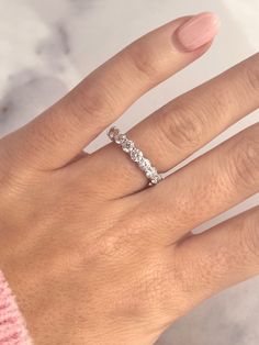 a woman's hand with a diamond ring on it