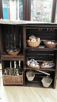 an old wooden cabinet with baskets and other items