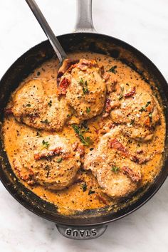 a skillet filled with meatballs covered in sauce