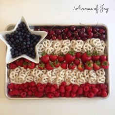 an american flag made out of pretzels, strawberries, and blueberries