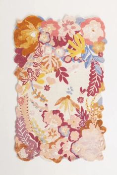 a piece of paper with flowers and leaves on the bottom, in various shades of pink, orange, yellow and white