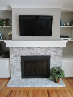 a living room with a television mounted above the fireplace