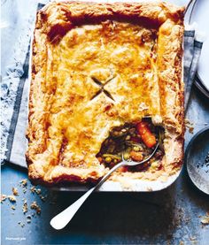 a pie with a spoon in it on top of a table