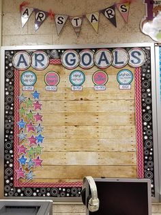 a bulletin board with writing on it in the middle of a school classroom wall decorated with stars