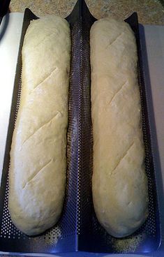 two loaves of bread sitting on top of a counter