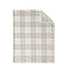 a white and beige checkered blanket on a white background