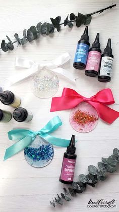 some crafting supplies are laid out on a table with ribbons and bows around them