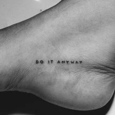 a black and white photo of a foot with the words do it anyway on it