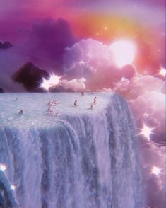 a waterfall with birds flying over it under a rainbow colored sky