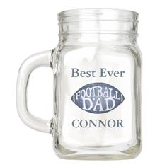 a glass mason jar with the words best ever and football dad on it's side