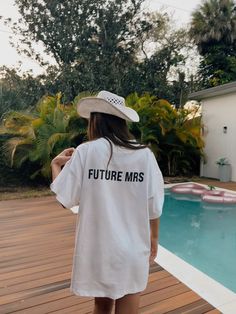 a woman wearing a white t - shirt that says future mrs in black on it