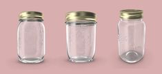 three glass jars with gold lids are shown in different positions on a light pink background