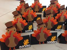 a table topped with lots of turkey place cards