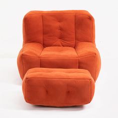 an orange chair and footstool sitting next to each other on a white background