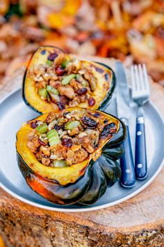 roasted stuffed squash on a plate with a fork and knife next to it, text reads roasted stuffed squash all in one thanksgiving meal