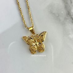 DESCRIPTION: Part of our exclusive "The Butterfly Effect Collection", the high polish 18K Gold Plated Butterfly Wish necklace features a double 3D butterfly design with beautifully crafted delicate details. It is the perfect piece to compliment any look! LENGTH: Multiple chain sizes available for selection above. Pendant: 0.8 inch. MATERIAL: 18K Gold Plated over Stainless Steel. Hypoallergenic, Tarnish Free and Water Resistant. Mix and match with any of our 18K Gold Necklaces and Anklets to crea Gold Plated Butterfly Necklace With Charm, Gold Plated Butterfly Charm Pendant Necklace, Gold Plated Butterfly Necklace As Gift, Gold-plated Gold Butterfly Necklace, Gold-plated Butterfly Necklace, Yellow Gold Plated Butterfly Necklace, Gold Butterfly Necklace For Gift, Dainty Gold Butterfly Necklace With Charm, Elegant Gold Butterfly Necklace