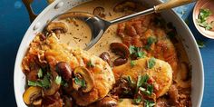 a casserole dish with mushrooms, meat and gravy in it on a blue table