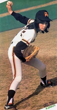 a young baseball player pitching a ball on top of a field