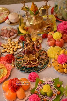 an assortment of food items displayed on a white tablecloth with gold trimmings