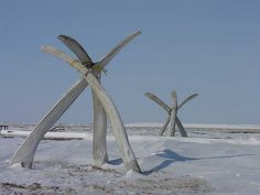 three large wooden sculptures sitting in the snow