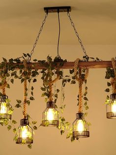 a bunch of lights that are hanging from a light fixture with plants growing out of them