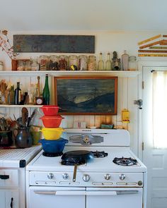 a white stove top oven sitting inside of a kitchen