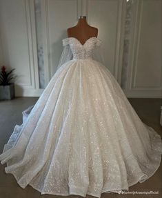 a white wedding dress with sequins on it