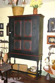 a black cabinet sitting on top of a wooden floor