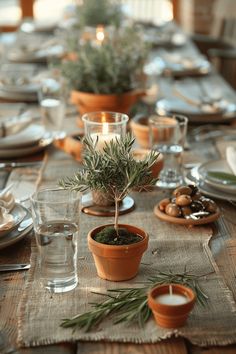 the table is set with dishes, cups and candles for dinner guests to sit at