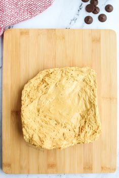 a loaf of bread on a cutting board next to chocolate chips