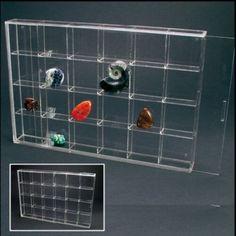 a clear acrylic display case with several different items in it and an image of the inside