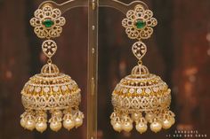 the earrings are adorned with pearls and green stones