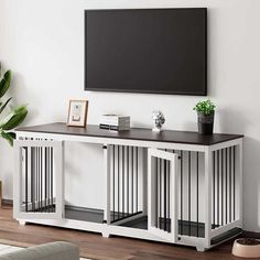 an entertainment center with a flat screen tv mounted on the wall above it and dog doors