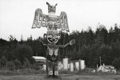 a large statue in the middle of a field with an eagle on it's head