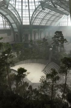 the inside of a building with trees in it