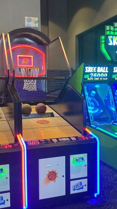 three basketball machines with neon lights on them