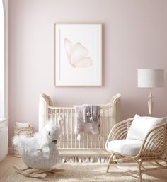 a baby's room with pink walls, white furniture and a rocking chair in front of the crib