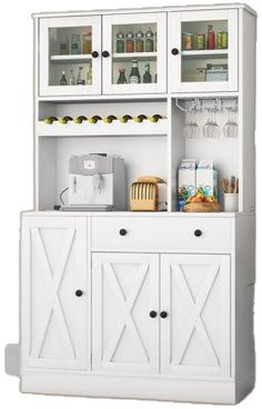 a white hutch filled with lots of bottles and glasses next to a counter top