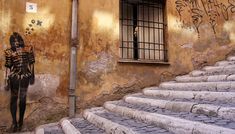 an old building with graffiti on the walls and stairs