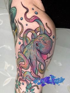 an octopus tattoo on the leg of a woman's legs with watercolors