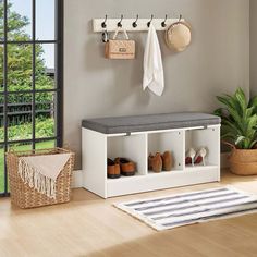 a room with a bench, potted plant and shoes on the shelf next to it