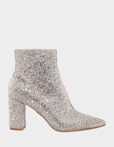 The CADY is a disco ready bootie that will take any outfit you wear to the next level. These ankle boots feature a pointed toe and a study, block heel and is fully decked out with rhinestones. Glitz and glam has never looked better. Heel height- 3.25 " Shaft height- 6", Circumference- 9.25", measured on a size 6 Allover rhinestone detailing Sparkly Silver Boots, Soarkle Boots, Disco Wedding Dress Sparkle, Sparkly Ankle Boots, Sparly Boots, Silver Sparkly Boots, White Sparkly Shoes, Sparkly White Boots, White Sparkly Boots