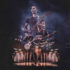 a man standing on top of a stage with guitars