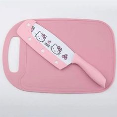 a pink cutting board with hello kitty on it