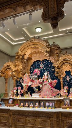 an idol in the middle of a room with many decorations on it's sides