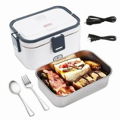 an image of a lunch box with food in it and utensils on the side