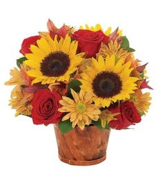 a bouquet of sunflowers and roses in a wooden vase on a white background