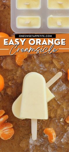 an orange ice cream popsicle sitting on top of some sliced oranges with the words easy orange creme